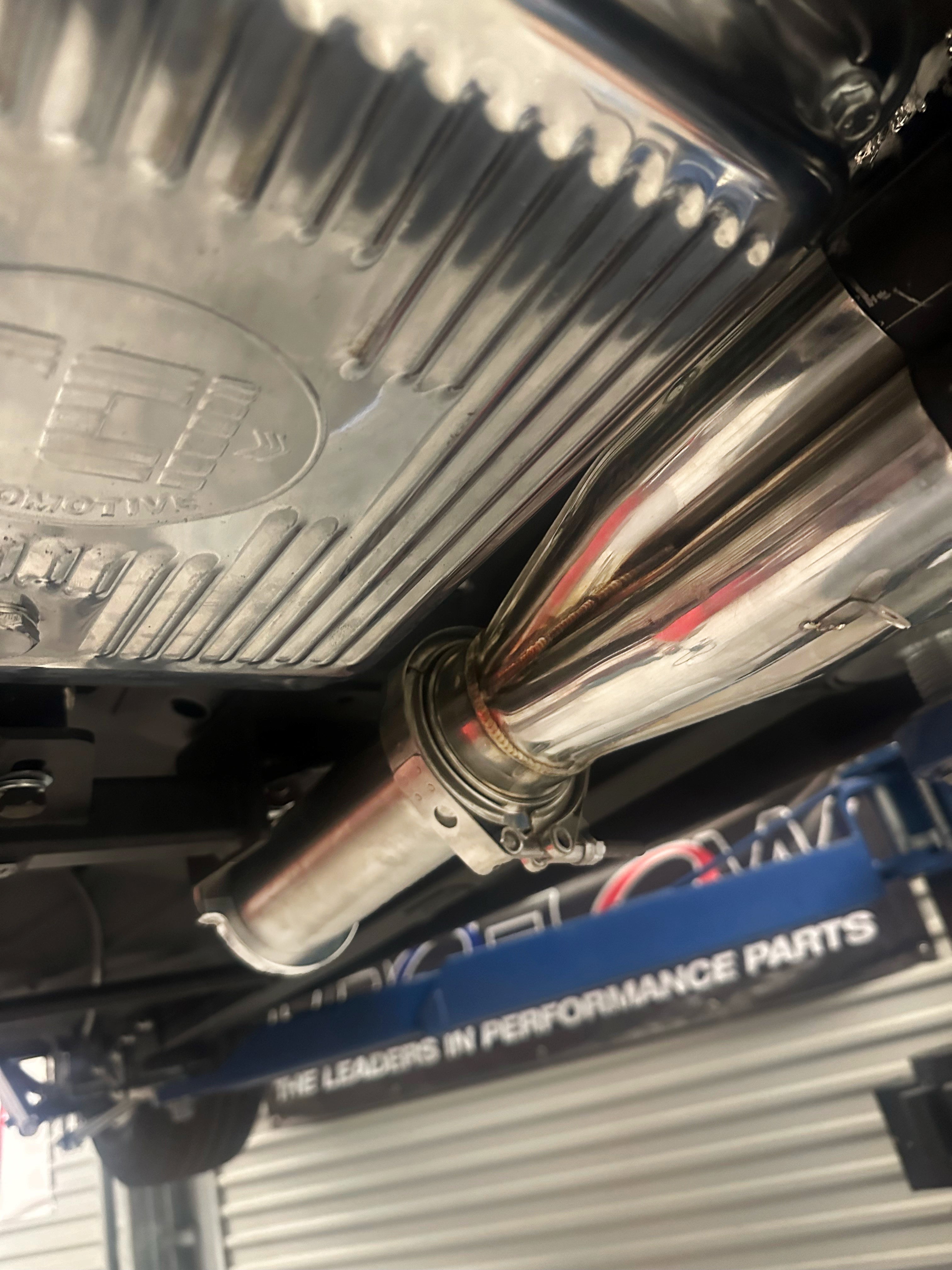 close up of a 4 into 1 racecraft merge collector during fabrication process underneath vehicle
