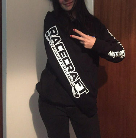 Person wearing a black hoodie with 'Racecraft' branding, making a peace sign.