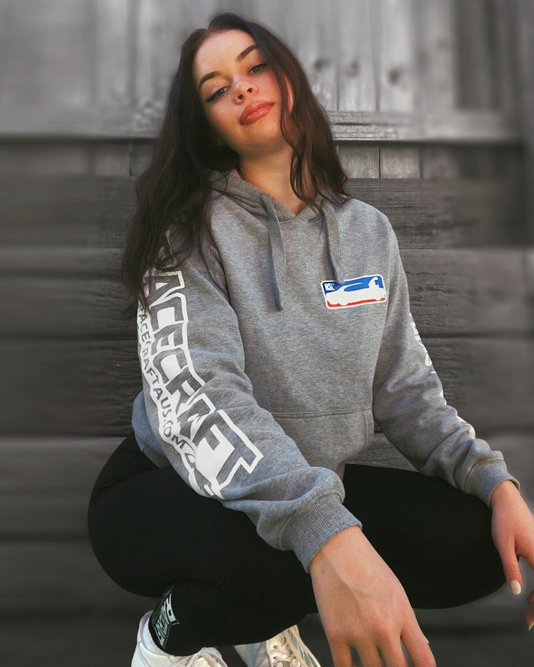 girl wearing a racecraft nsl grey hoodie front view