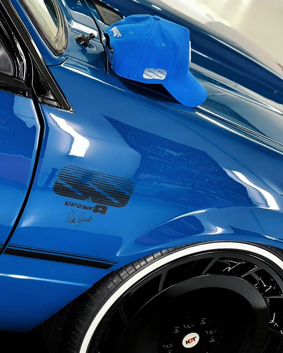 blue meanie vk ss group-a cap sat on bonnet of vk ss group a car