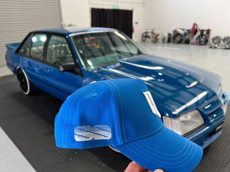 close u of blue meanie vk ss group-a cap held in front of vk ss group a car