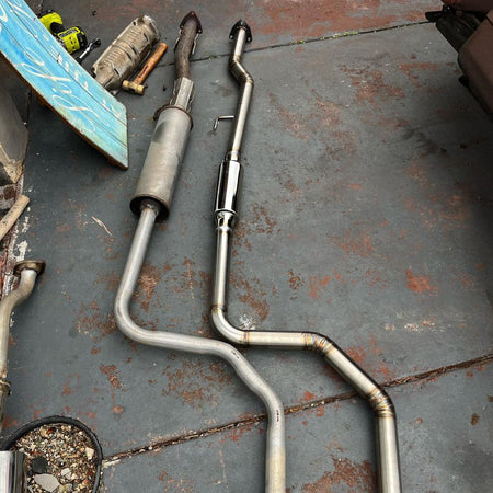 racecraft resonator fabricated into custom exhaust next to factory exhaust