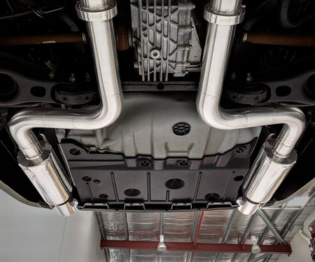 racecraft round stainless mufflers on chrysler 300c with custom exhaust at the rear facing away