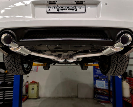 racecraft round stainless mufflers on chrysler 300c with custom exhaust at the rear view closeup