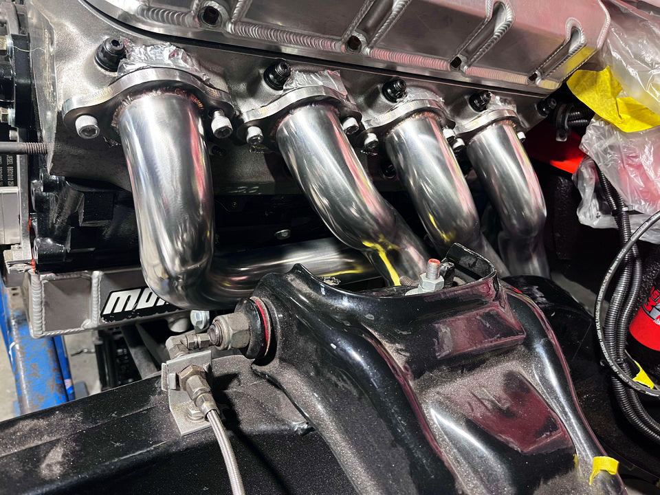 racecraft stainless steel polished mandrel bends used to fabricate custom headers  in engine bay
